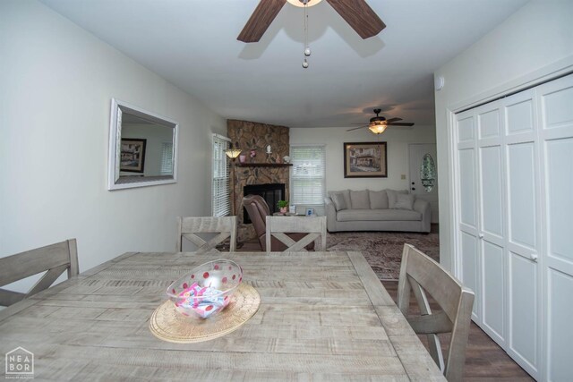 1123 Olive St, Jonesboro, AR 72401 - dining space featuring a ceiling fan and a stone fireplace