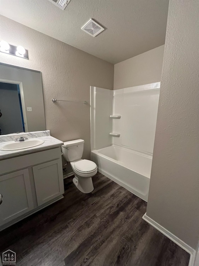 3804 Glitterman Dr, Jonesboro, AR 72404 - full bathroom featuring a textured wall, wood finished floors, vanity, toilet, and a textured ceiling