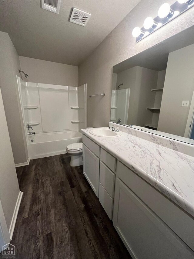 3804 Glitterman Dr, Jonesboro, AR 72404 - full bathroom featuring wood finished floors, vanity, shower / tub combination, and toilet