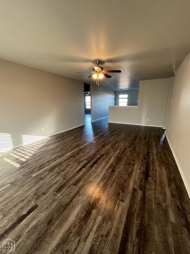 3804 Glitterman Dr, Jonesboro, AR 72404 - empty room featuring dark wood-type flooring, ceiling fan, and baseboards
