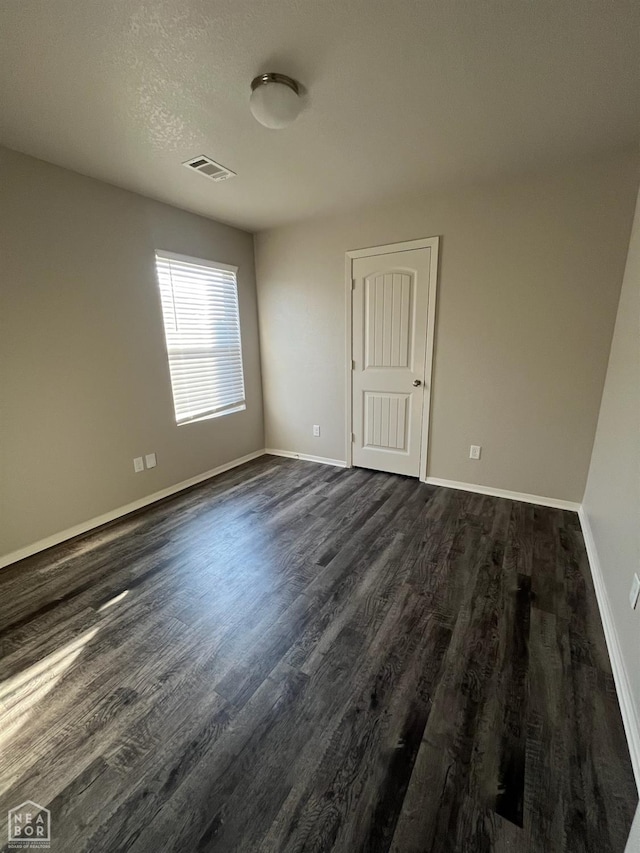 3804 Glitterman Dr, Jonesboro, AR 72404 - unfurnished room with dark wood-style floors and baseboards