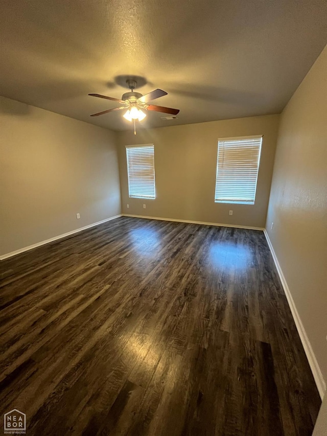 3804 Glitterman Dr, Jonesboro, AR 72404 - spare room with dark wood finished floors, a ceiling fan, and baseboards