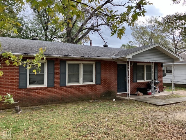 2204 Parkside Dr, Jonesboro, AR 72401 - ranch-style house featuring brick siding, a front lawn, a shingled roof, and a patio area