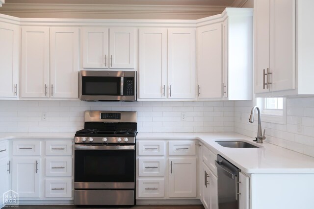 113 Hidden Creek Dr, Brookland, AR 72417 - kitchen with appliances with stainless steel finishes, a sink, white cabinetry, light countertops, and crown molding