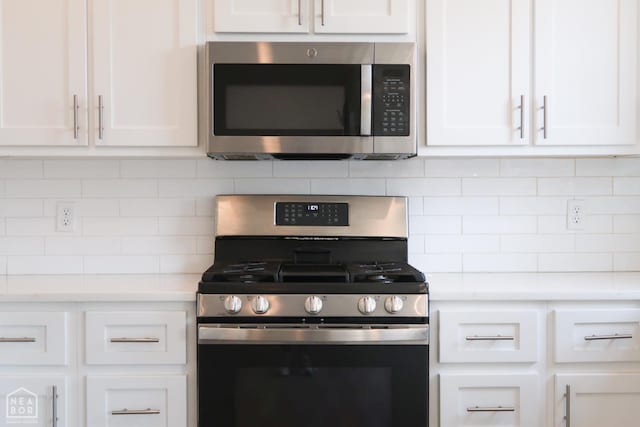 113 Hidden Creek Dr, Brookland, AR 72417 - kitchen featuring stainless steel appliances, white cabinets, decorative backsplash, and light countertops