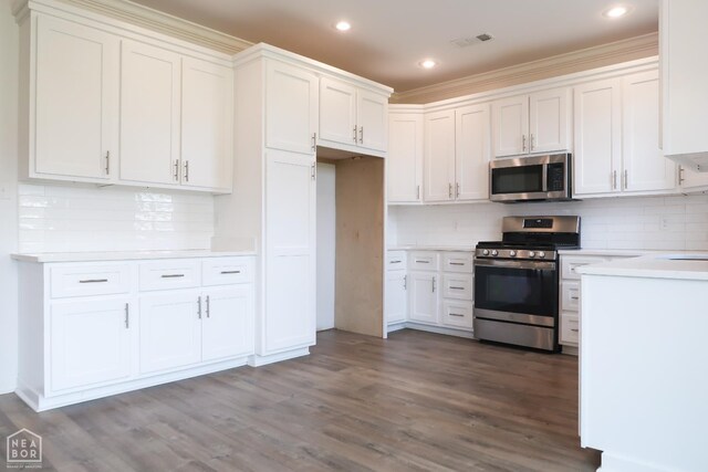 113 Hidden Creek Dr, Brookland, AR 72417 - kitchen with appliances with stainless steel finishes, light countertops, decorative backsplash, white cabinetry, and recessed lighting