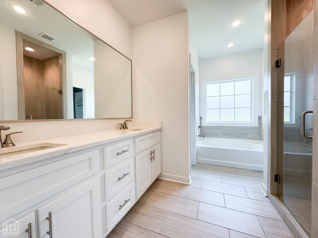 113 Hidden Creek Dr, Brookland, AR 72417 - full bathroom with a shower stall, double vanity, a bath, baseboards, and recessed lighting