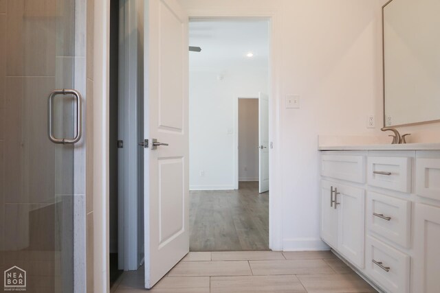 113 Hidden Creek Dr, Brookland, AR 72417 - bathroom featuring vanity, baseboards, and a shower with shower door