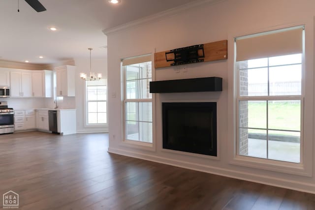 113 Hidden Creek Dr, Brookland, AR 72417 - unfurnished living room featuring a chandelier, crown molding, plenty of natural light, a fireplace, and dark wood-style floors