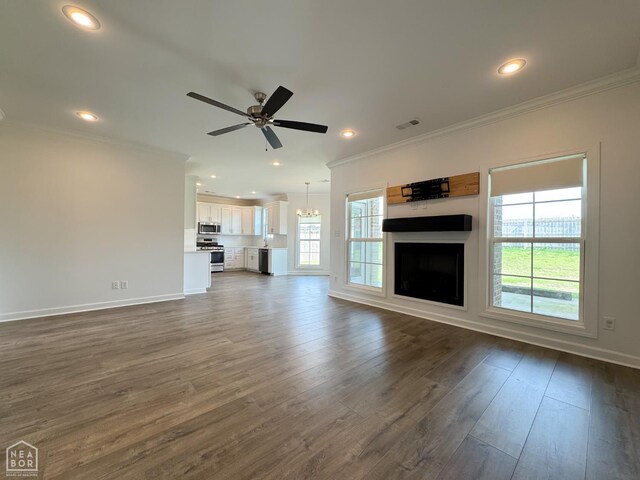 113 Hidden Creek Dr, Brookland, AR 72417 - unfurnished living room with crown molding, ceiling fan, dark wood-type flooring, baseboards, and recessed lighting