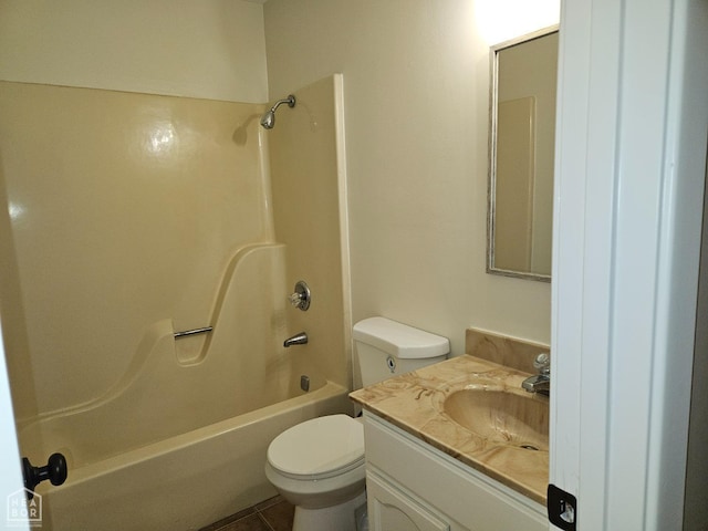 bathroom with toilet, tile patterned floors, vanity, and washtub / shower combination
