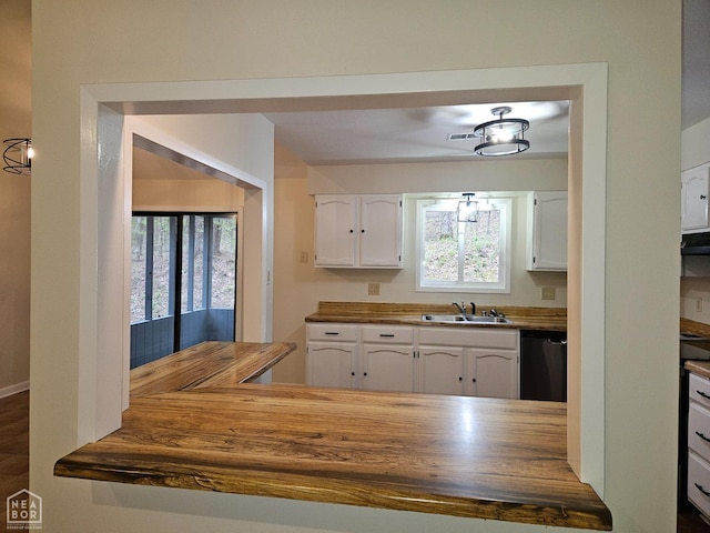 kitchen with a sink, wooden counters, white cabinetry, and dishwasher