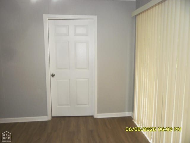 404 Logan St, Newport, AR 72112 - unfurnished bedroom with dark wood-style floors and baseboards