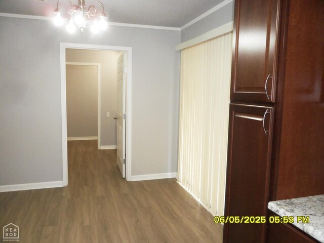 404 Logan St, Newport, AR 72112 - hall with wood finished floors, crown molding, a chandelier, and baseboards
