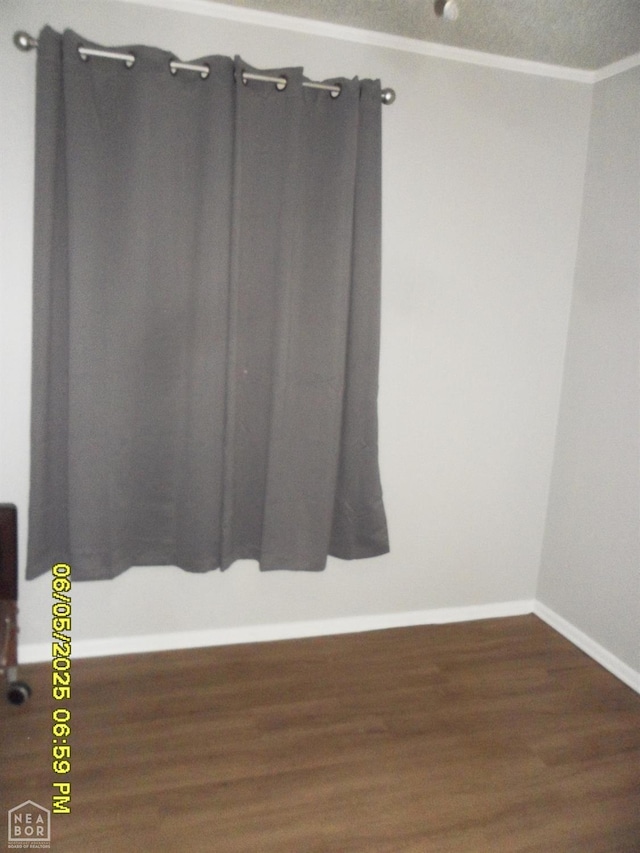 404 Logan St, Newport, AR 72112 - spare room with baseboards, wood finished floors, and crown molding