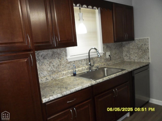 404 Logan St, Newport, AR 72112 - kitchen featuring stainless steel dishwasher, a sink, backsplash, baseboards, and light stone countertops