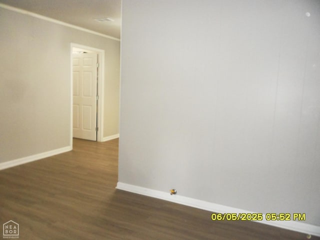 404 Logan St, Newport, AR 72112 - empty room with baseboards, dark wood-style flooring, and crown molding