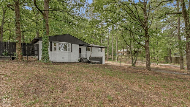 view of yard with fence and a garage