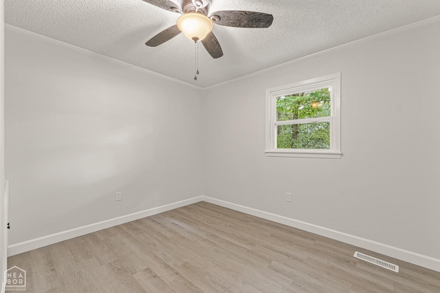 unfurnished room with light wood finished floors, a textured ceiling, baseboards, and visible vents