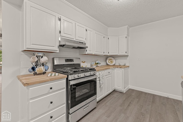 kitchen with light wood-style flooring, a textured ceiling, white cabinetry, under cabinet range hood, and gas stove
