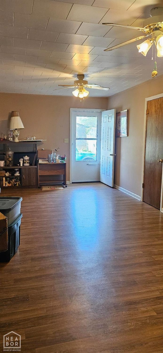 living room with wood finished floors, baseboards, and ceiling fan