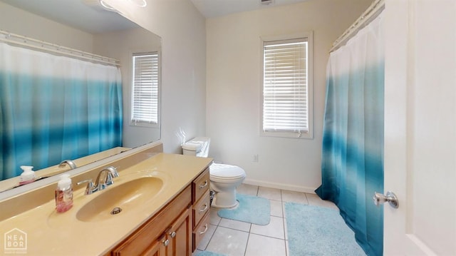 bathroom featuring toilet, tile patterned floors, plenty of natural light, and vanity