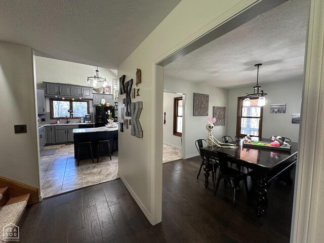 13534 Mc 8001, Yellville, AR 72687 - dining area featuring a chandelier, dark wood-style flooring, a textured ceiling, and baseboards