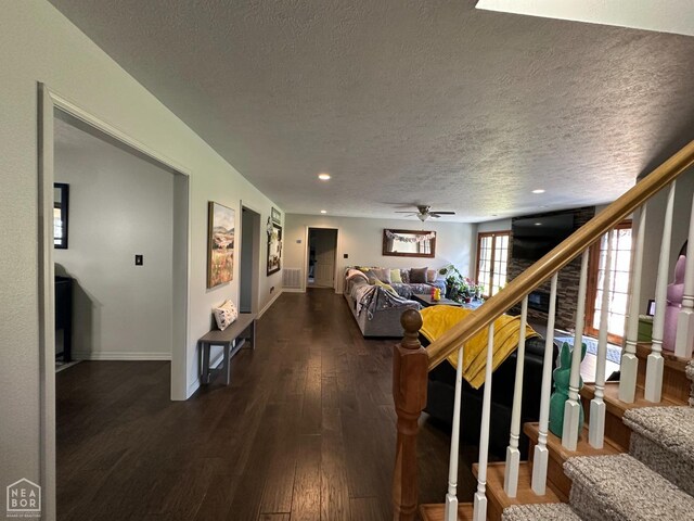 13534 Mc 8001, Yellville, AR 72687 - living room with dark wood-type flooring, a textured ceiling, a ceiling fan, stairway, and baseboards