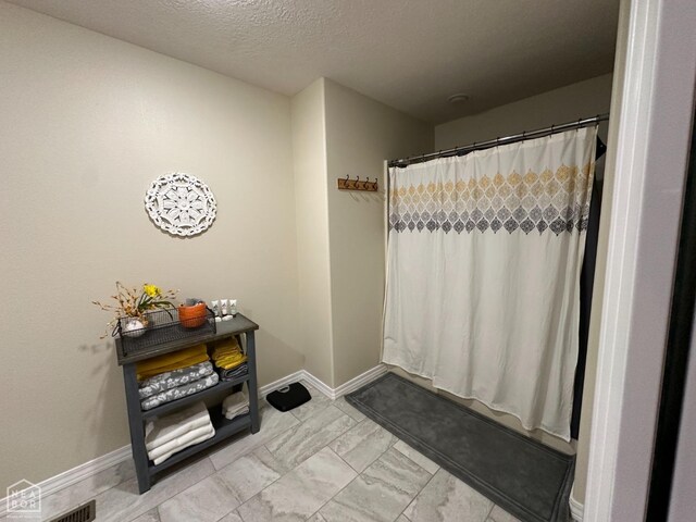 13534 Mc 8001, Yellville, AR 72687 - full bath with a textured ceiling, marble finish floor, a shower with shower curtain, and baseboards