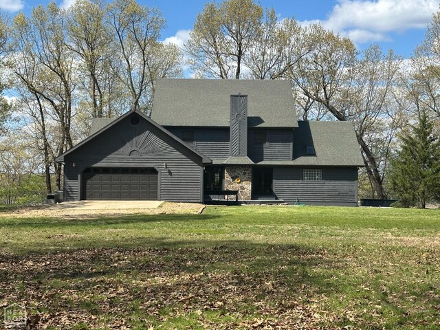 13534 Mc 8001, Yellville, AR 72687 - view of front of home featuring a garage, a front yard, and a chimney