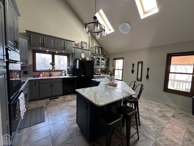 13534 Mc 8001, Yellville, AR 72687 - kitchen with high vaulted ceiling, black appliances, a kitchen island, a sink, and gray cabinetry