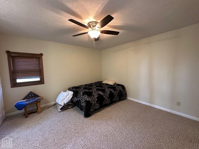 13534 Mc 8001, Yellville, AR 72687 - bedroom with a textured ceiling, carpet flooring, baseboards, and a ceiling fan
