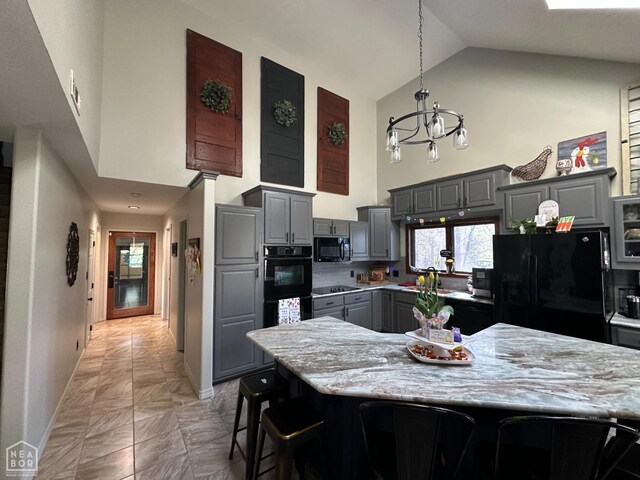 13534 Mc 8001, Yellville, AR 72687 - kitchen with baseboards, a chandelier, gray cabinetry, high vaulted ceiling, and black appliances