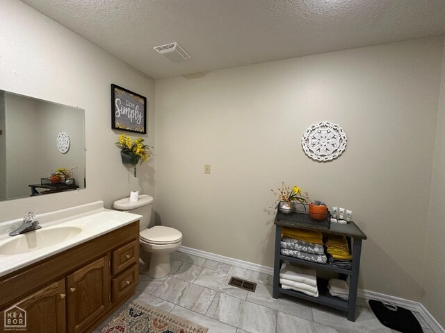 13534 Mc 8001, Yellville, AR 72687 - half bathroom featuring toilet, a textured ceiling, vanity, and visible vents