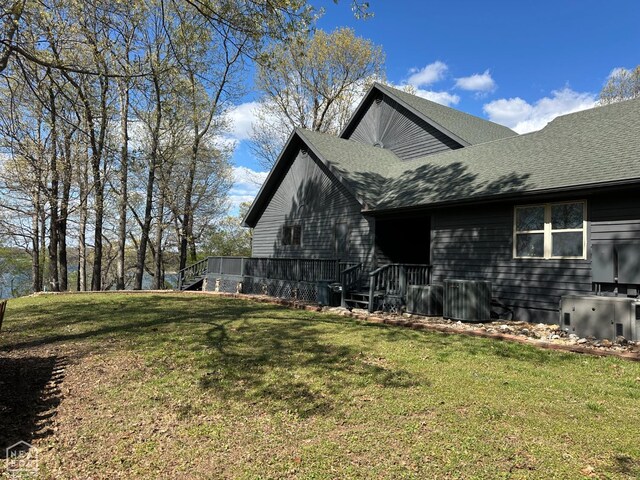 13534 Mc 8001, Yellville, AR 72687 - view of side of property with cooling unit, roof with shingles, and a lawn