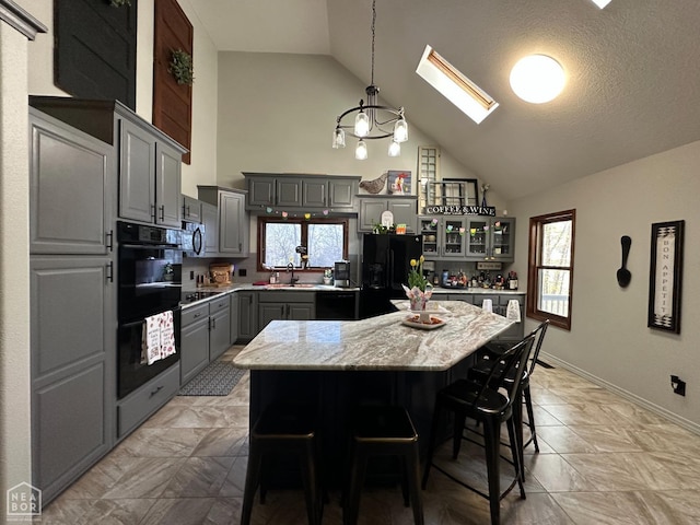13534 Mc 8001, Yellville, AR 72687 - kitchen with a sink, black appliances, gray cabinetry, a skylight, and high vaulted ceiling