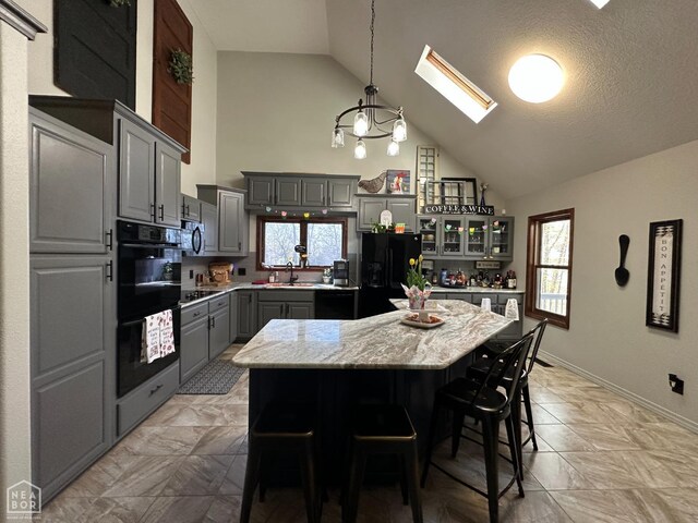 13534 Mc 8001, Yellville, AR 72687 - kitchen featuring a sink, black appliances, gray cabinets, a skylight, and high vaulted ceiling