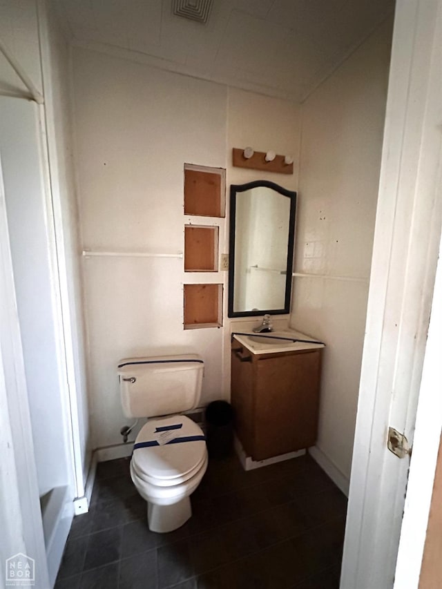 bathroom featuring tile patterned flooring, vanity, visible vents, and toilet