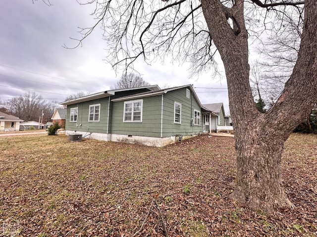 view of property exterior featuring crawl space and cooling unit