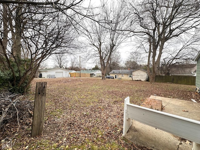 view of yard with fence and a garage