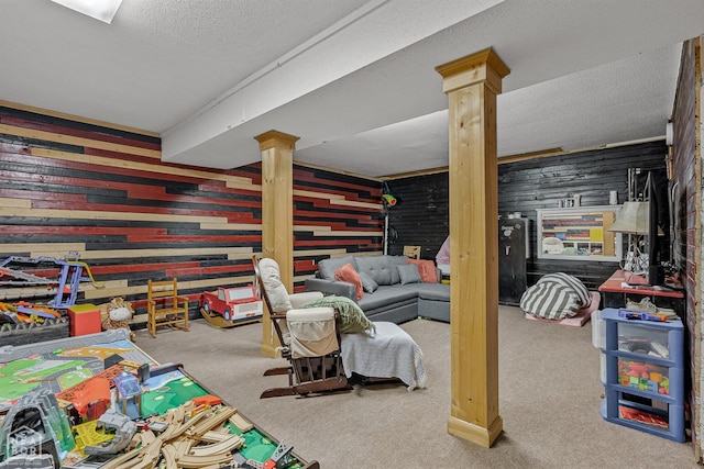 1617 Strawfloor Dr, Jonesboro, AR 72404 - rec room featuring decorative columns, carpet, wooden walls, and a textured ceiling
