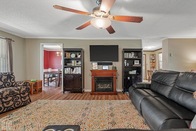 1617 Strawfloor Dr, Jonesboro, AR 72404 - living area with a textured ceiling, wood finished floors, crown molding, a ceiling fan, and a fireplace