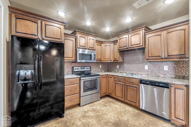 398 Wildwood Pt, Jonesboro, AR 72405 - kitchen with visible vents, appliances with stainless steel finishes, tasteful backsplash, a sink, and recessed lighting