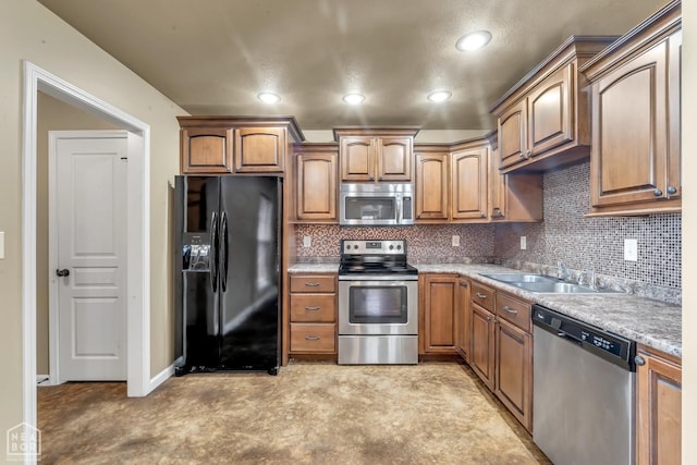 398 Wildwood Pt, Jonesboro, AR 72405 - kitchen featuring backsplash, stainless steel appliances, brown cabinets, and a sink