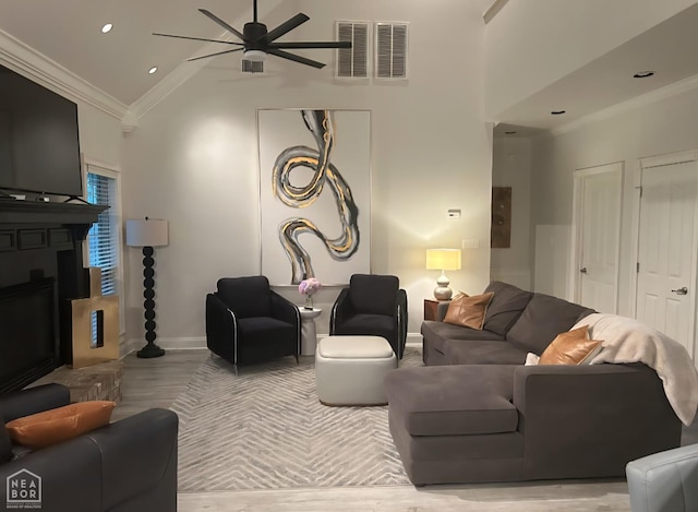 3305 Winged Foot Cv, Jonesboro, AR 72405 - living room featuring ornamental molding, ceiling fan, a large fireplace, high vaulted ceiling, and wood finished floors
