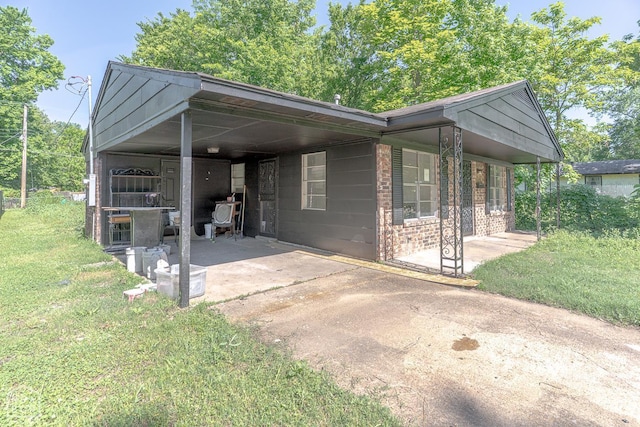 325 S 12th St, West Memphis, AR 72301 - view of front facade with a front lawn, a carport, and driveway