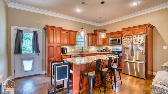 509 Wiregrass Way, Jonesboro, AR 72405 - kitchen featuring stainless steel appliances, concrete flooring, brown cabinets, crown molding, and a kitchen island