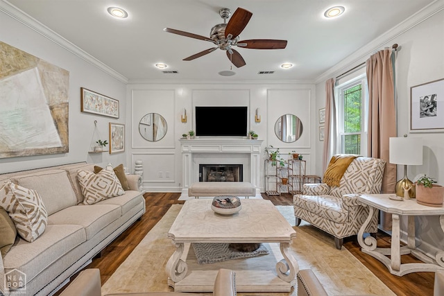 3821 Pebble Beach Dr, Jonesboro, AR 72404 - living area featuring ornamental molding, wood finished floors, a ceiling fan, a glass covered fireplace, and a decorative wall