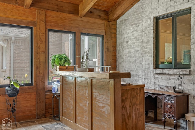 3821 Pebble Beach Dr, Jonesboro, AR 72404 - interior space featuring wooden ceiling with exposed beams, wooden walls, stone finish flooring, and brick wall
