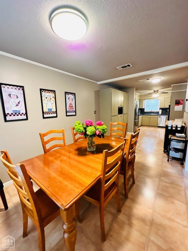 2804 Ivy Dr, Newport, AR 72112 - dining space featuring a textured ceiling and ornamental molding